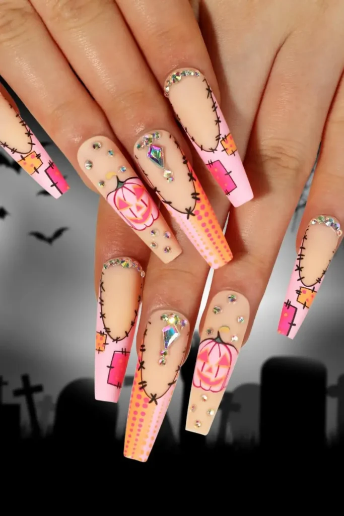 9. Rhinestone and Pink Pumpkin Coffin Nails